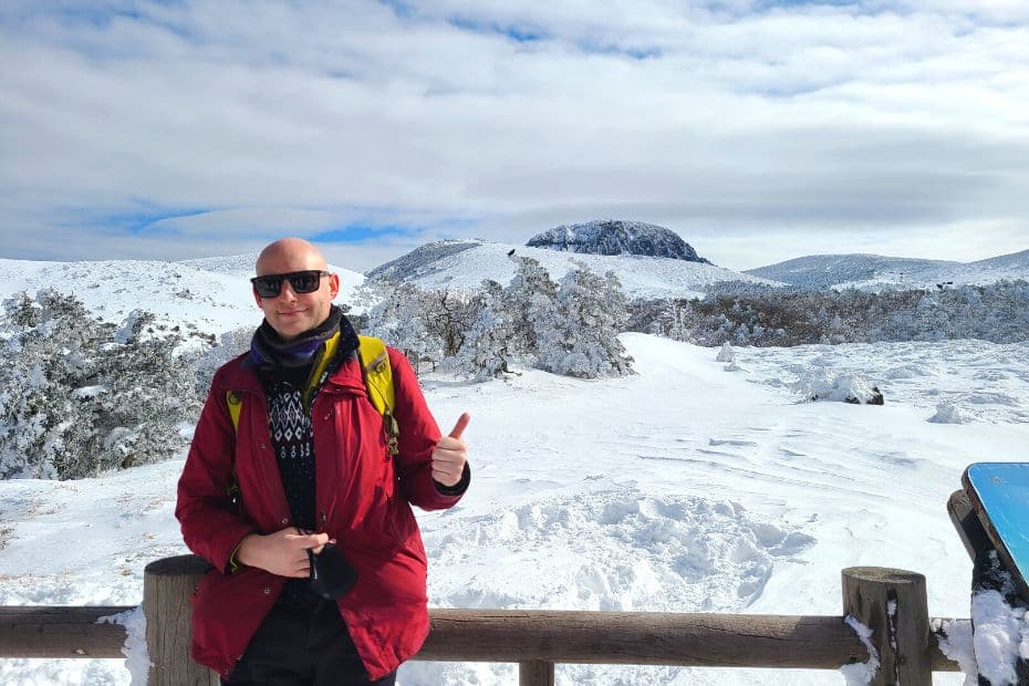 Man overlooking the peak of Hallasan Mountain in snow