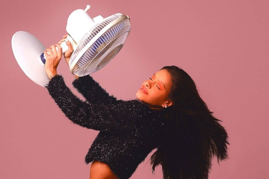 Woman keeping cool with a fan