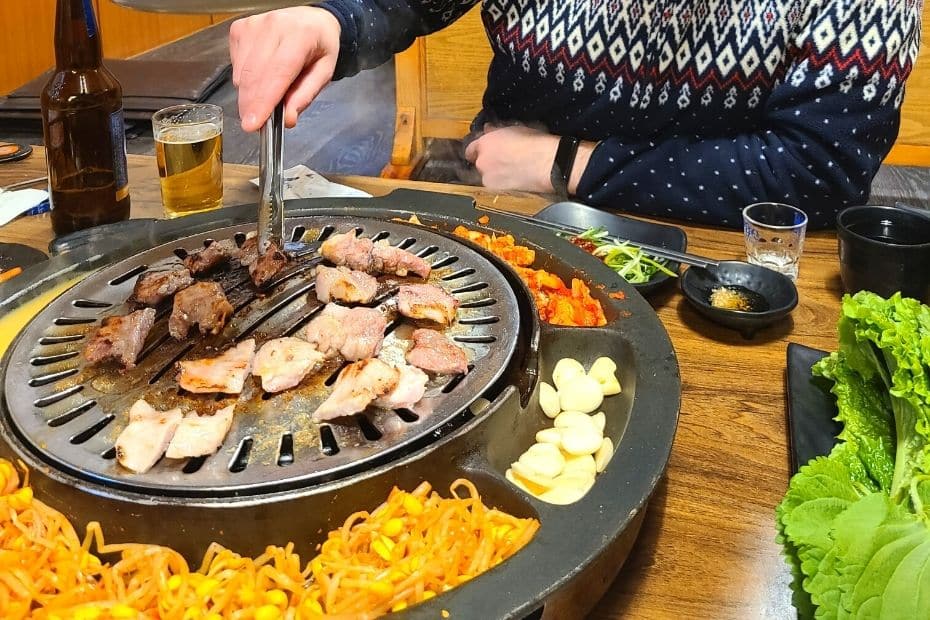 Eating Korean BBQ, a traditional Korean dish