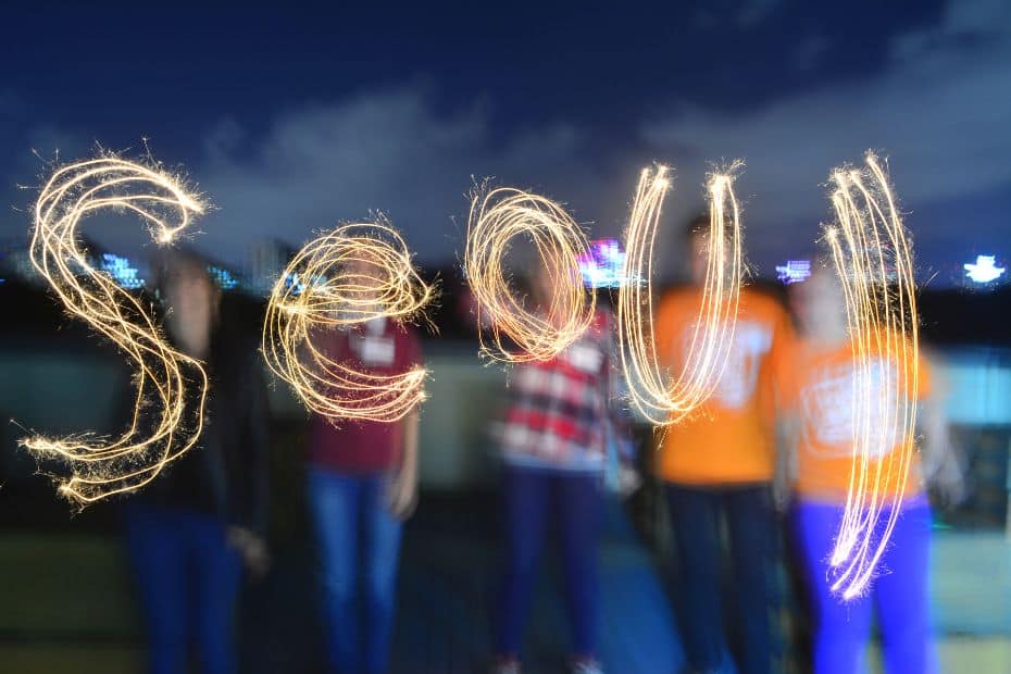 People writing Seoul with sparklers