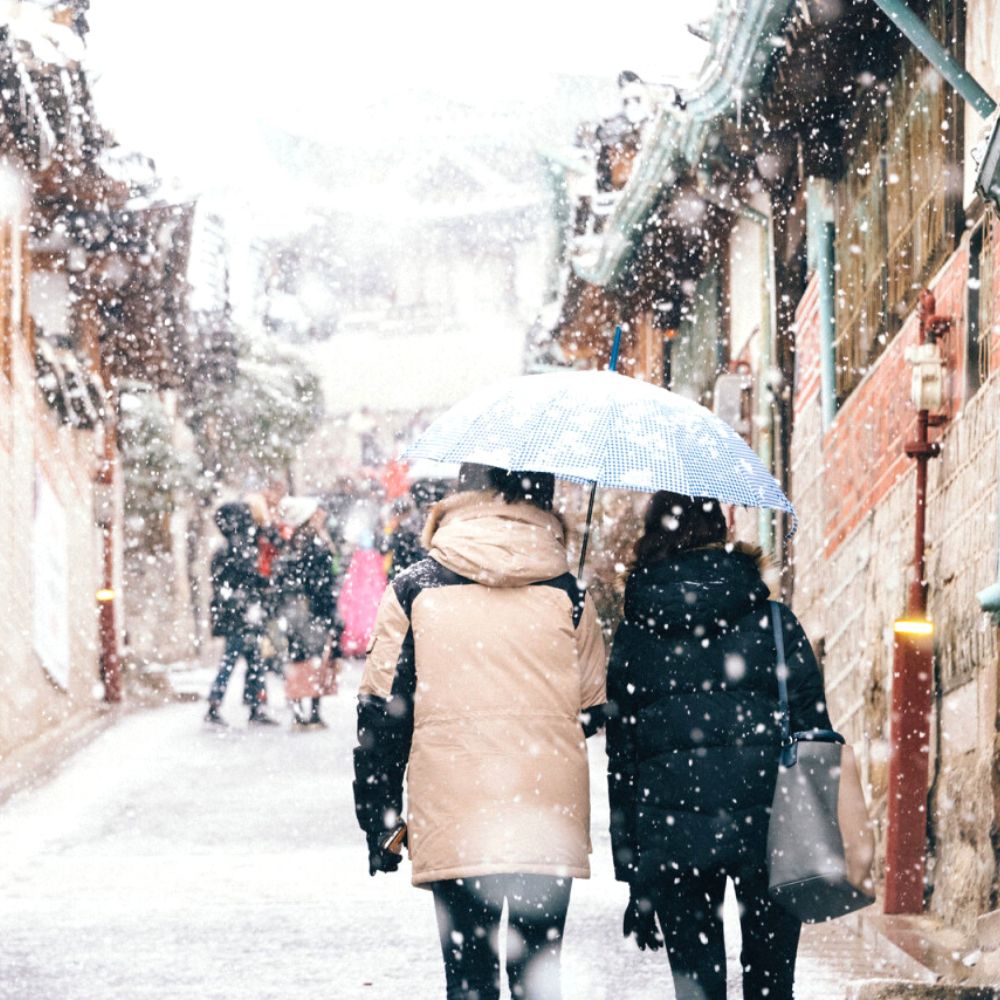 Where Does It Snow In Korea? Snow In Seoul And Korea 2025 9 People walking in snow in Bukchon Hanok Village Seoul