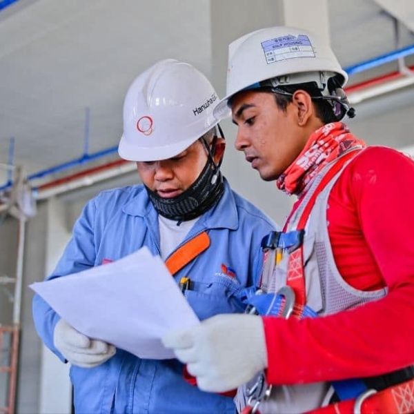 Foreigners in safety clothing working in Korea