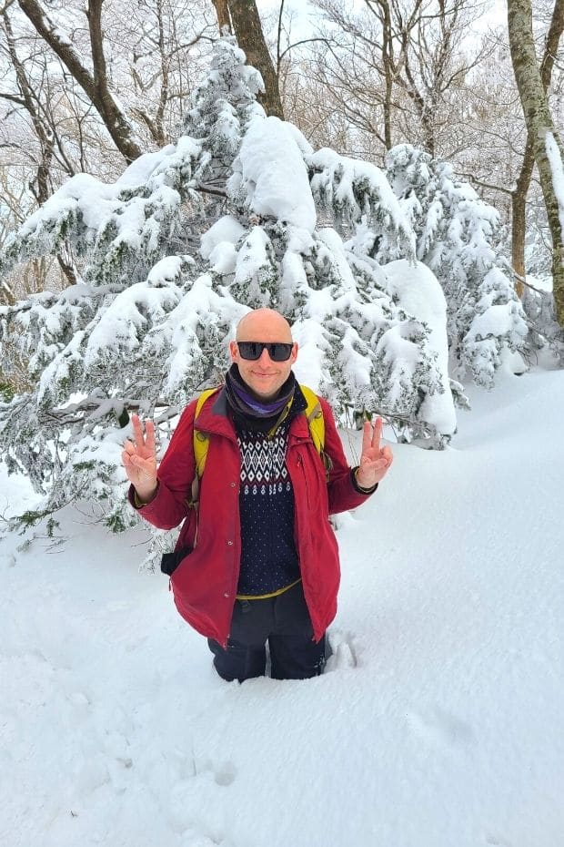 Joel in deep snow while hiking Hallasan Mountain in winter