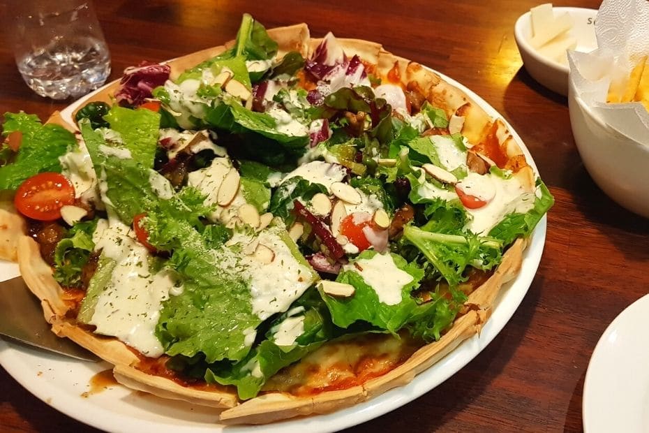 Weird Korean pizza with lots of salad on top