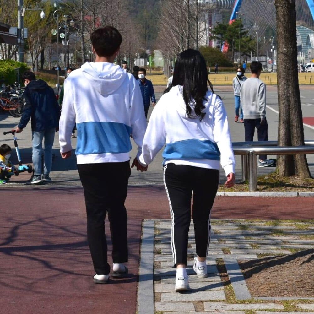 Korean Couple Showing Affection With Couples Clothing
