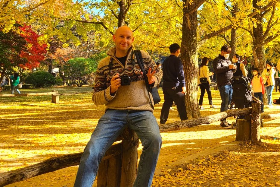 Man posing for picture with ginkgo leaves