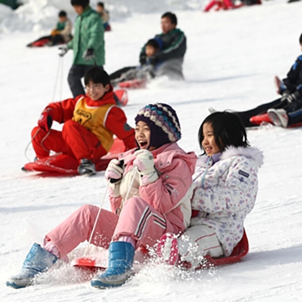 Snow sledding at Ttukseom Han River Park in Seoul