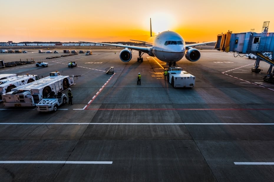 Flight connecting at an airport at sunset