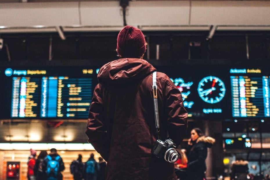 Man looking at a flight departure timetable