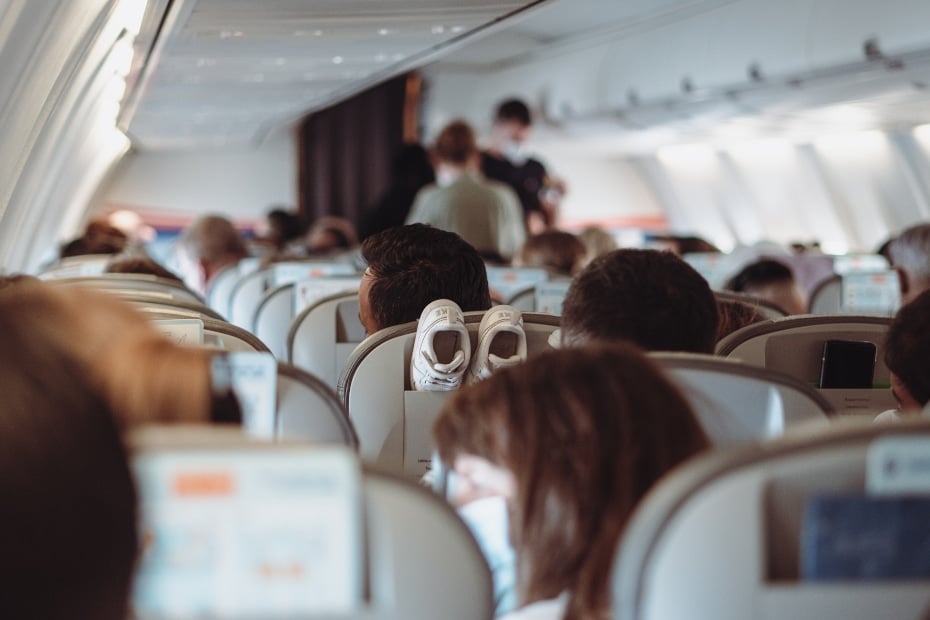 Person wearing a face mask on a flight