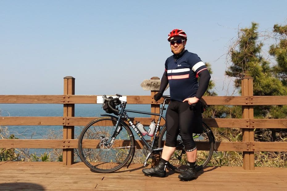 Tim with his bike cycling in Korea