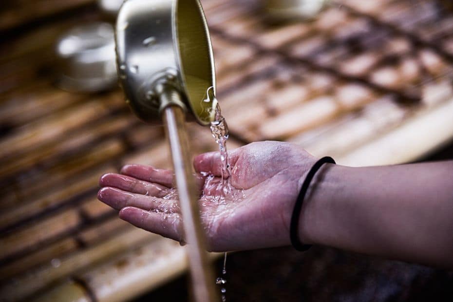 Person washing their hands at a temple in Korea