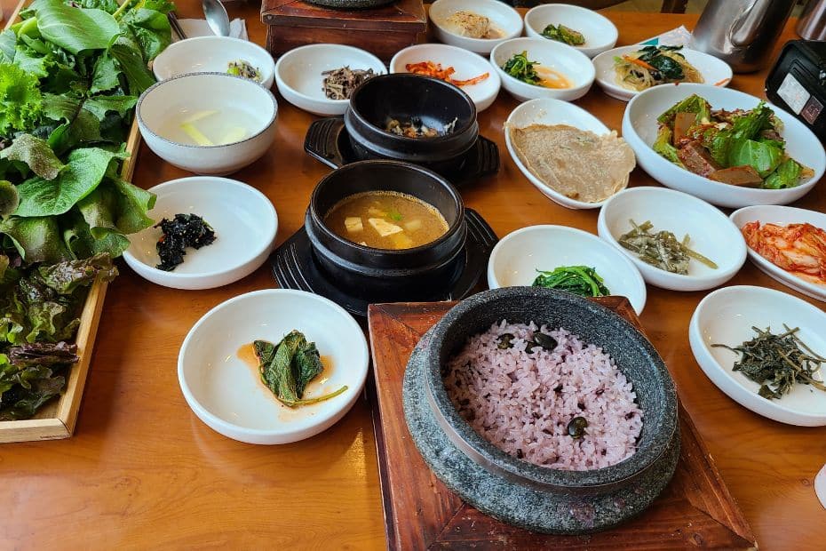 Korean side dishes with a meal of wrapped lettuce leaves