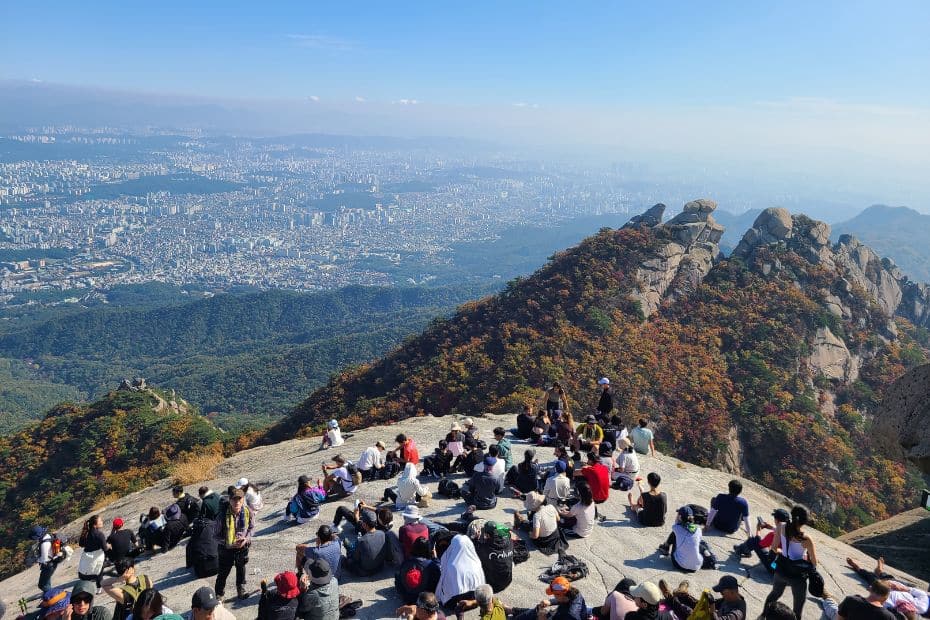 People resting and views of Seoul from Baegundae Peak