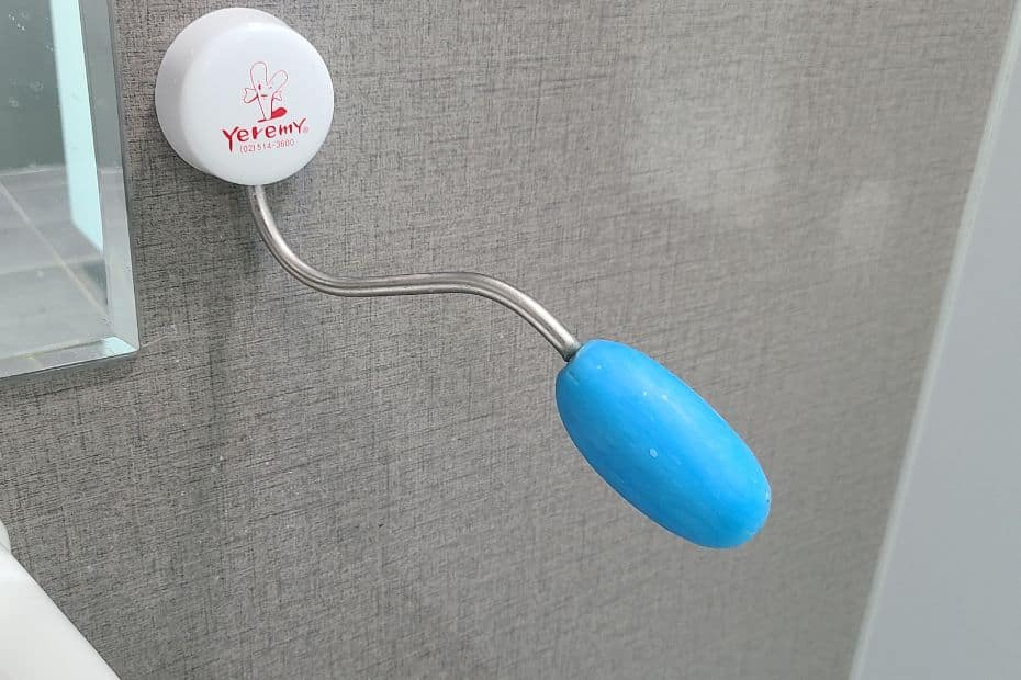 Blue soap on a metal pole in a Korean public toilet