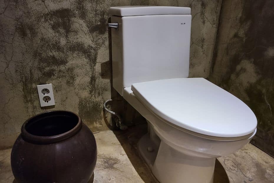 Korean toilet with a metal bin