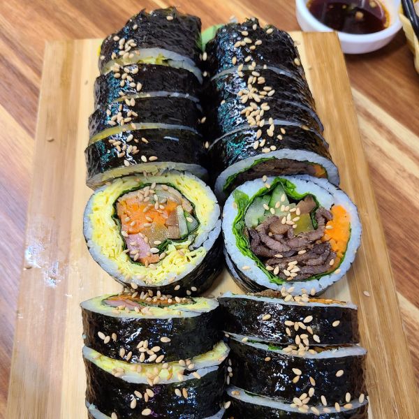 Two gimbap rolls with various fillings