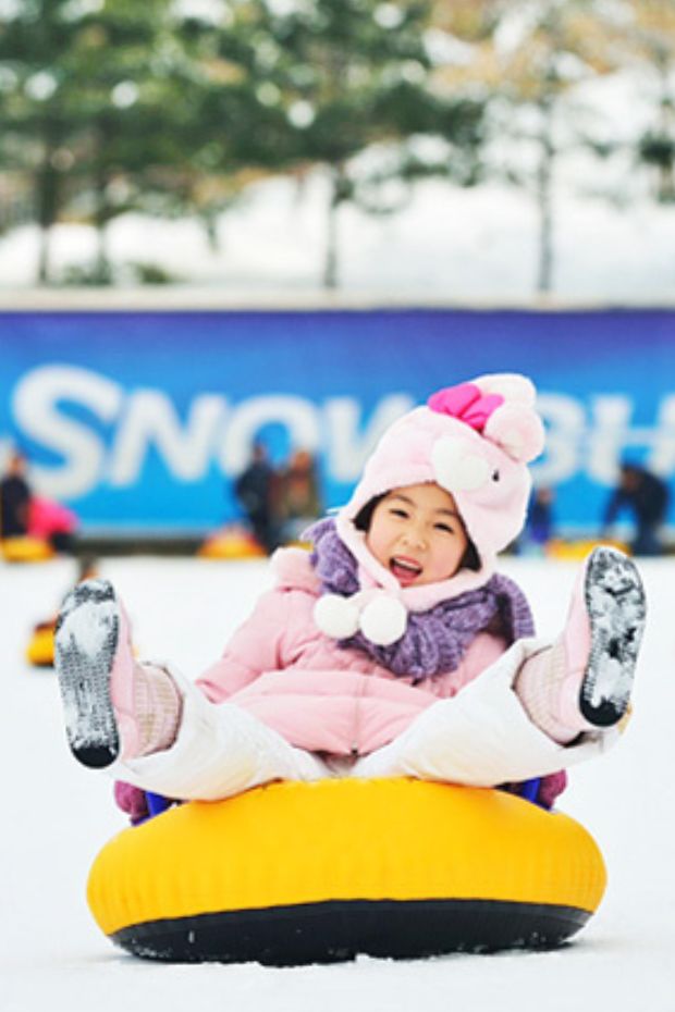 Child on a rubber ring in snow