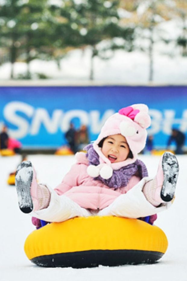 The Best Winter Festivals In Korea You Must Visit In 2025 16 Child on a rubber ring in snow