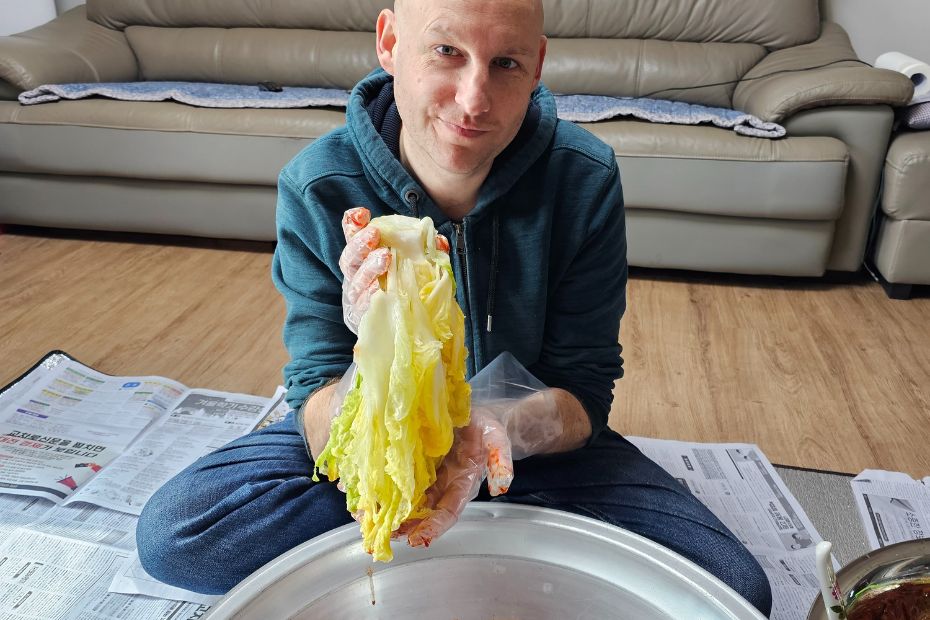 I Tried Kimjang! Korean Kimchi Making Day Is Tough But Fun 4 Man making kimchi with baechu cabbage