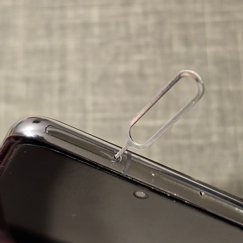 Metal hook to access SIM card